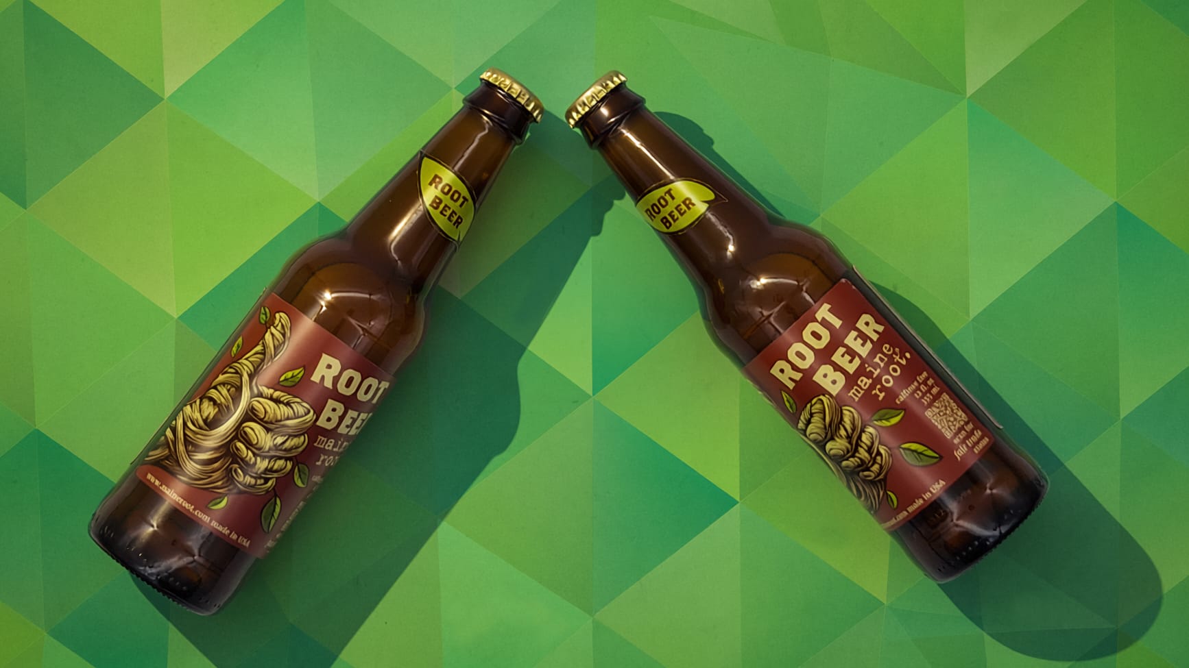 Two refreshed Maine Root Root Beer bottles laying together in a top-down product shot.